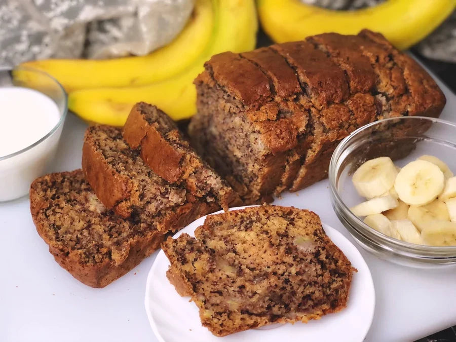 Sliced moist banana bread on a wooden board