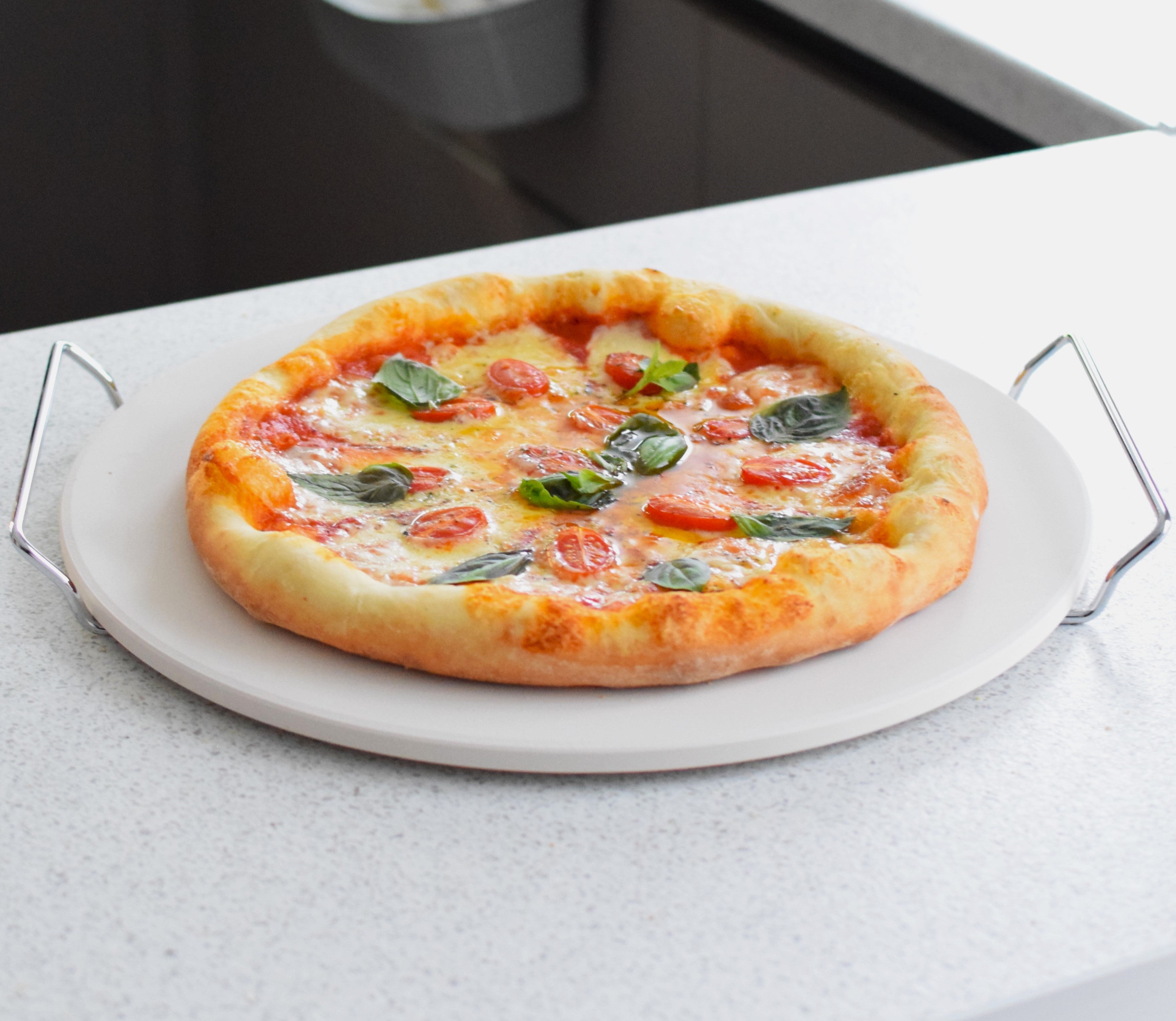 homemade crispy crust pizza on cordierite pizza baking stone with handles                      